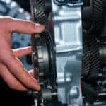 Hands working on the transmission of a vehicle