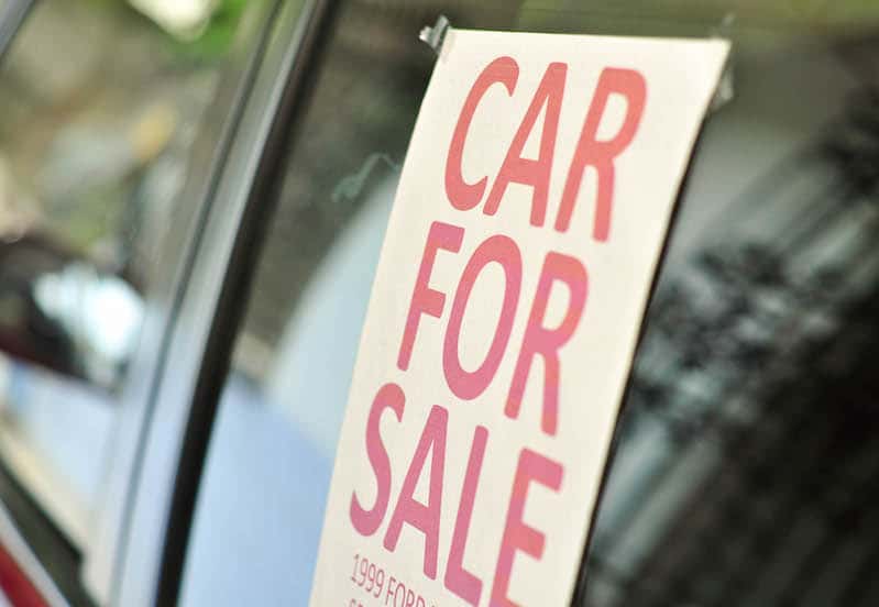 Car for Sale sign on the window of a vehicle