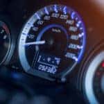 Lit up dashboard of a vehicle showing 92,382 miles