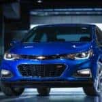 Blue 2016 Chevrolet Cruze sedan parked in a dark, black garage