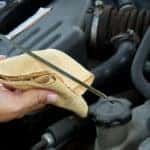 Mechanic checking the oil of a vehicle