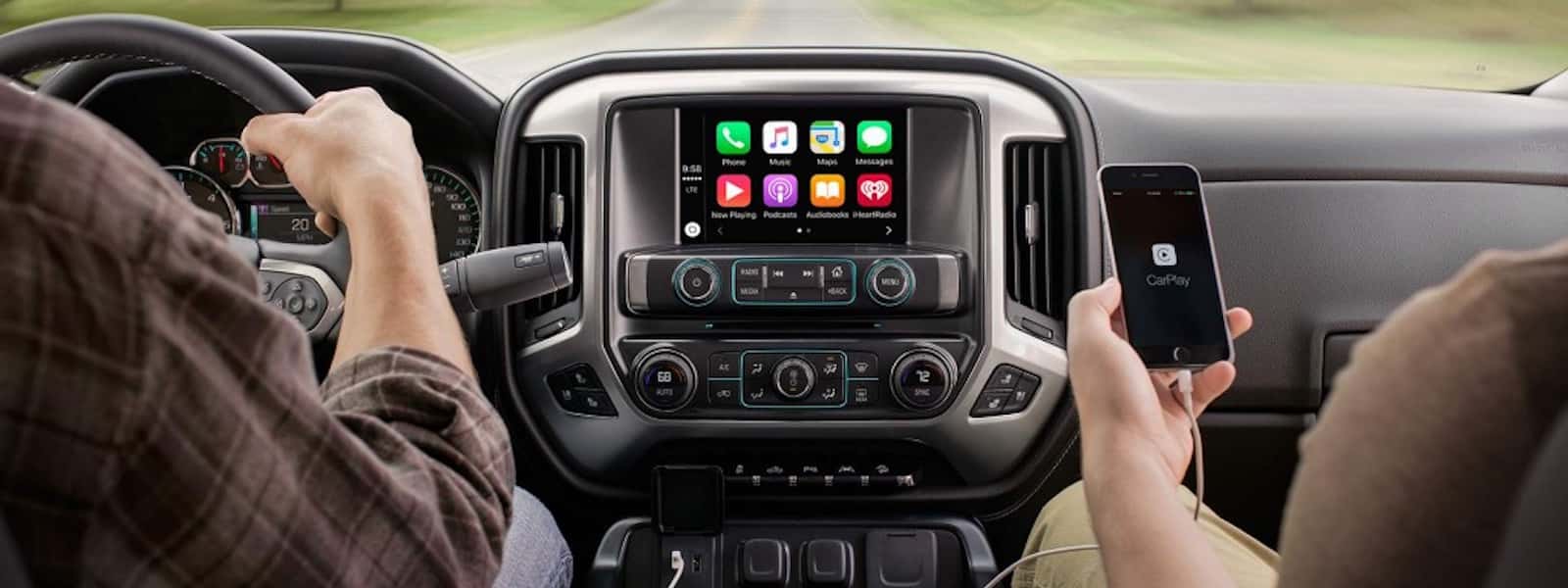 Apple Car Play is being used on a phone in a 2016 Chevy Silverado.