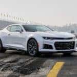 White 2017 Chevrolet Camaro ZL1 parked across a racetrack with stands in the background