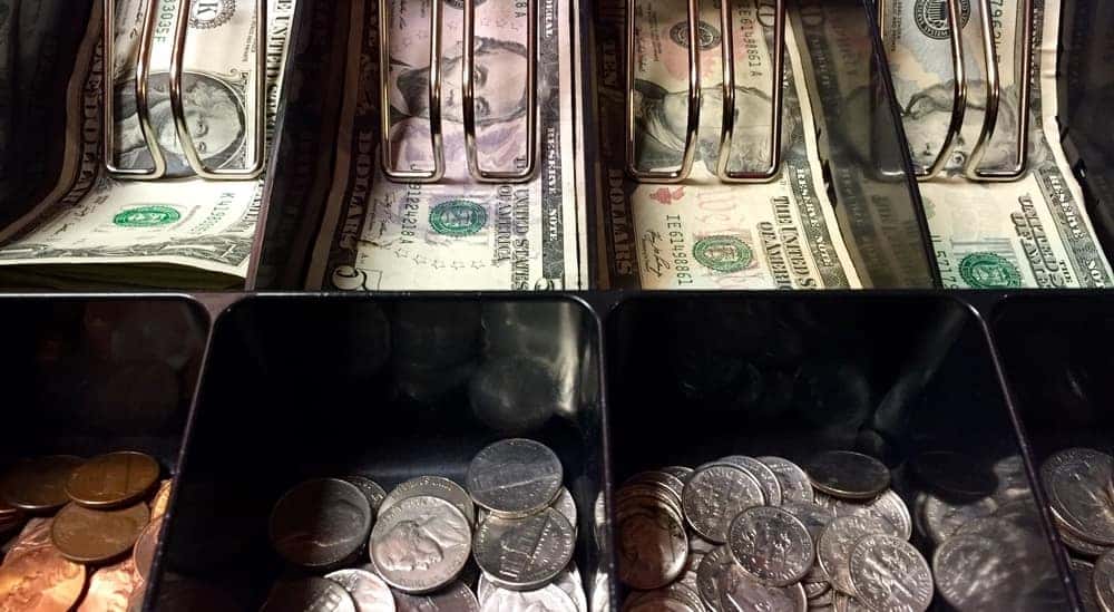 Cash and coins sorted neatly inside the drawer of a register