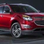 Red 2016 Chevrolet Equinox against a black background