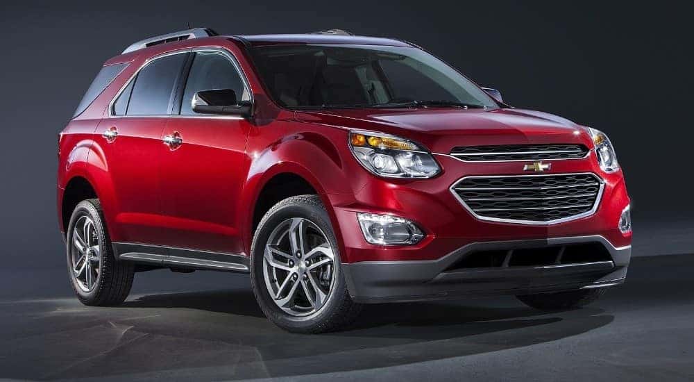 Red 2016 Chevrolet Equinox against a black background