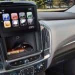 Infotainment system in the 2018 Traverse lifted up to reveal a secret storage compartment
