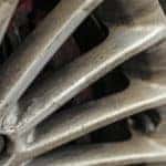 Close-up of dirt and oil residue on a vehicle's rims