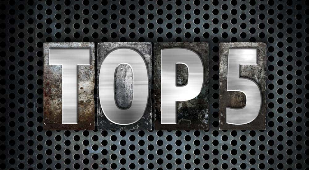 Words "Top 5" written in letterpress type on blocks against an industrial background