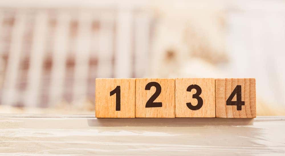 Wooden blocks with black numbers one them counting from one to four