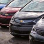 Various colors of the 2017 Chevrolet Bolt EV parked diagonally in a parking lot