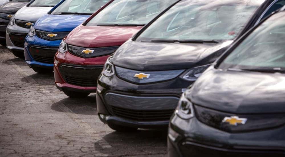 Various colors of the 2017 Chevrolet Bolt EV parked diagonally in a parking lot
