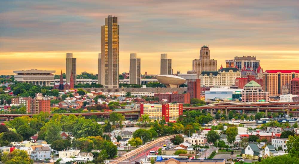 Tall Albany buildings and busy roads at dusk