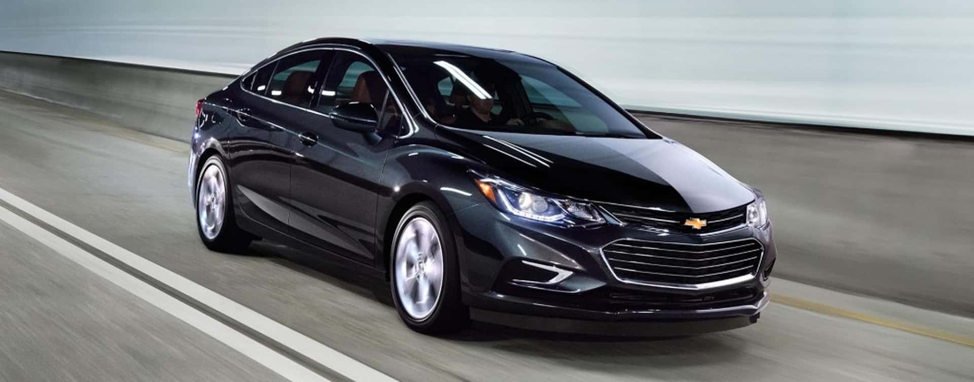 A black 2017 Chevy Cruze sedan is driving in a tunnel near Albany, NY.