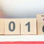Brown blocks with black numbers on them that say "2016" with the last block flipping to show a "7"