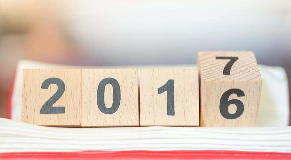 Brown blocks with black numbers on them that say "2016" with the last block flipping to show a "7"