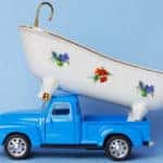 Blue toy pickup truck with a white toy tub on top of it