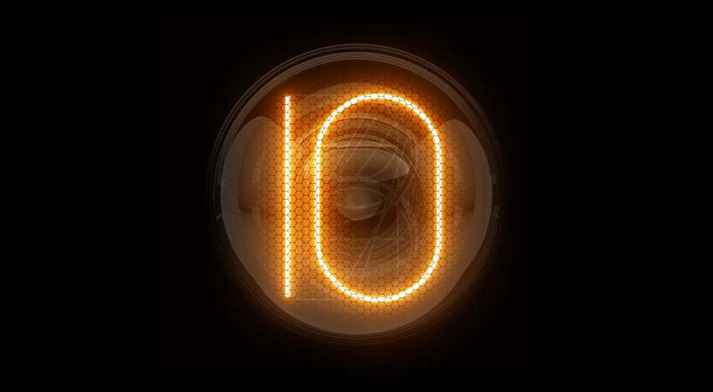 Number "10" lit up digitally by orange lights in the center of a circle against a black background