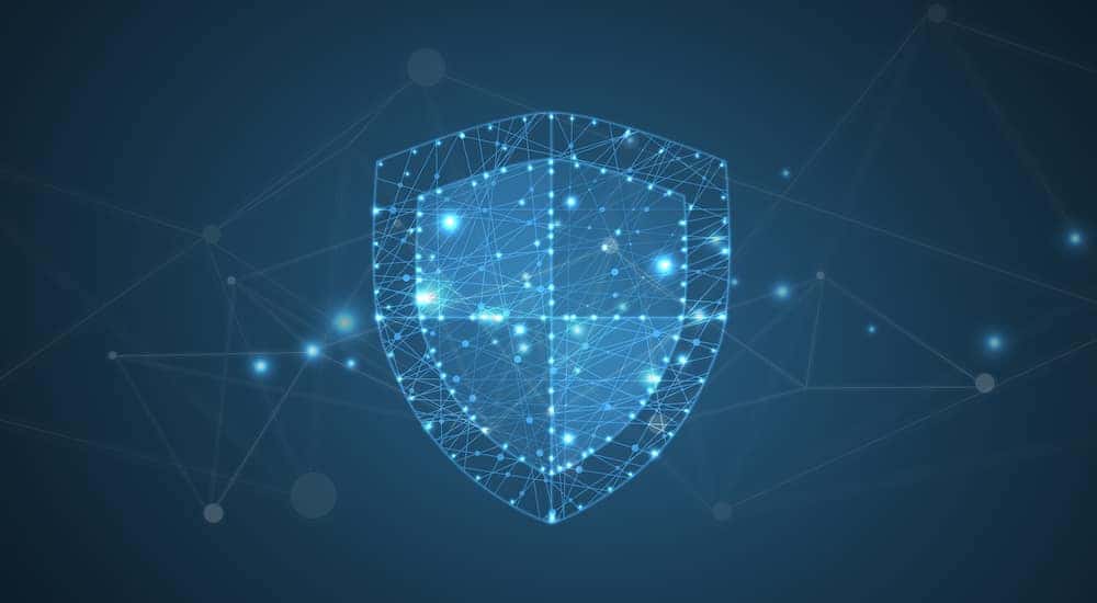 Blue, glowing shield in front of a dark background