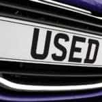 Close up of blue vehicle's license plate that says "USED" on it