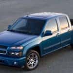 Blue 2012 Chevrolet Colorado parked diagonally across pavement