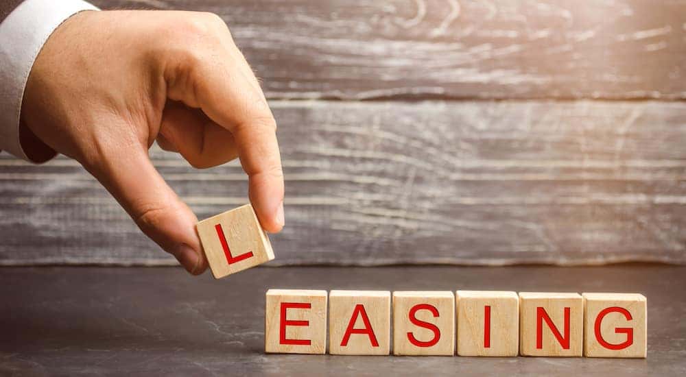 Brown blocked with red letters on them that spell out the word "LEASING"