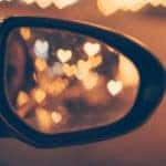 Heart shaped reflections in the side mirror of a vehicle