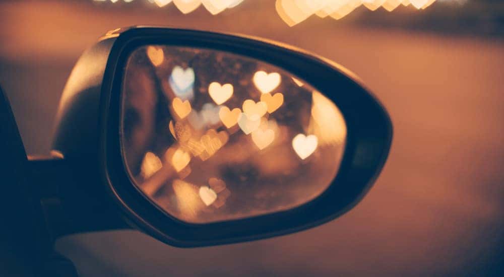 Heart shaped reflections in the side mirror of a vehicle