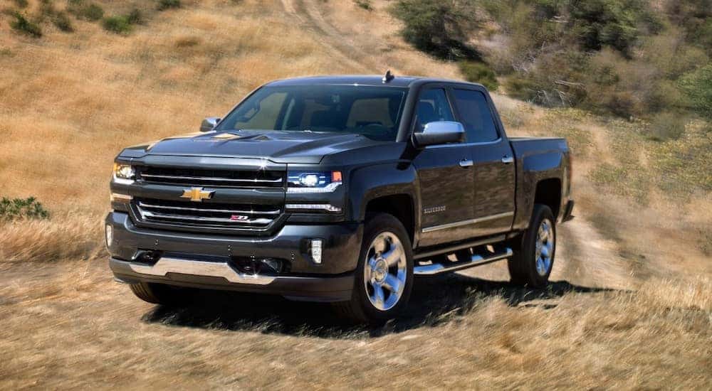 2018 Chevrolet Silverado pickup truck parked at the bottom of a grassy hill
