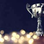 Silver trophy on a brown table covered in LED lights