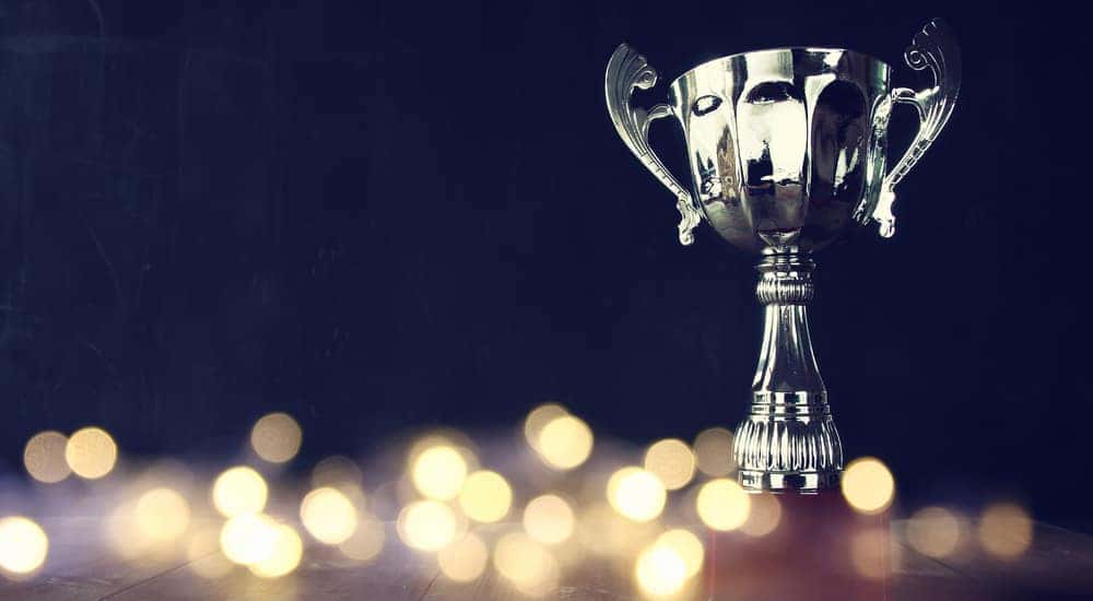 Silver trophy on a brown table covered in LED lights