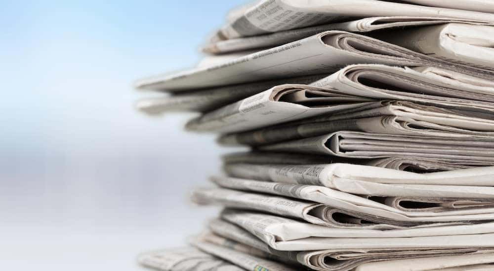 Stack of newspapers with a light blue and white background