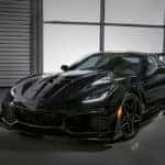 Black 2019 Chevrolet Corvette ZR1 parked in a room with grey floors, grey walls, and a large window