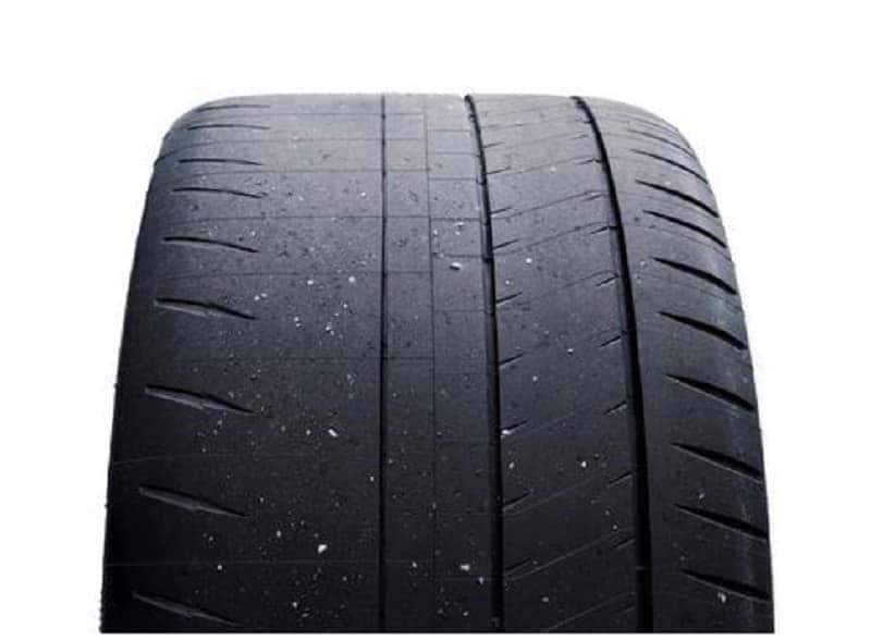 Black rubber tire showing uneven and significant tread loss on the left side