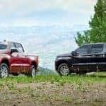 Two 2020 Chevy Silverado are parked on a grassy hill outside of Albany, NY.