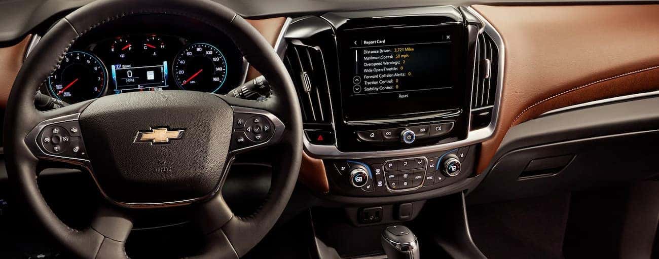 The dashboard and brown interior of the 2020 Chevy Traverse is shown.