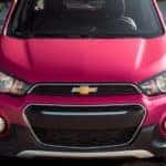 A red 2020 Chevy Spark is parked in a parking lot facing forward.