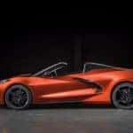 An orange 2020 Chevy Corvette is parked in a dark garage near Albany, NY.