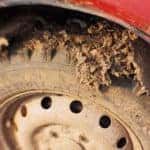 Close up of mud on the tire of a red vehicle