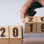 Four number blocks that say "2019" with the last two being flipped by a hand to make out "2020"