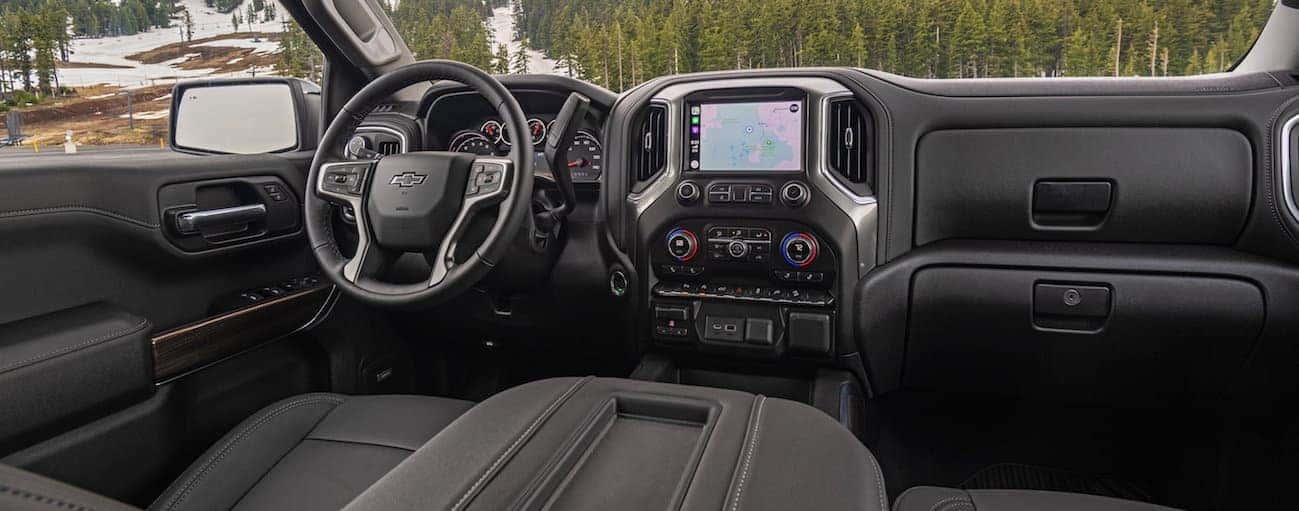The front black leather interior of a 2020 Chevy Silverado 1500 is shown.