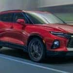 A red 2020 Chevy Blazer, a vehicle that you could get great Chevy lease deals on, is driving on a highway near Albany, NY.