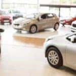 Cars are shown in a dealerships showroom.