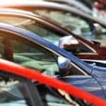 A row of used cars is shown at a used car lot.