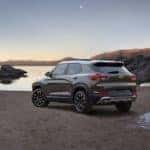 Brown and white 2021 Chevrolet Trailblazer parked in dirt by the edge of a lake