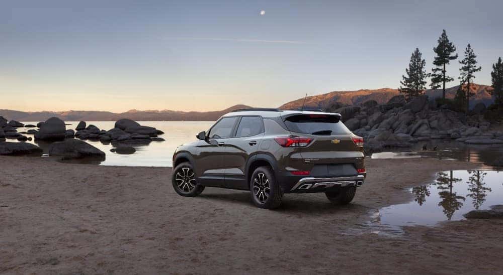 Brown and white 2021 Chevrolet Trailblazer parked in dirt by the edge of a lake