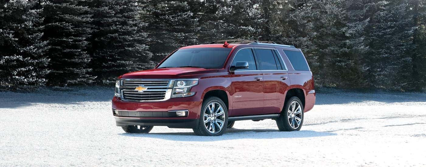 A red 2020 Chevy Tahoe is parked in the snow in Albany, NY.
