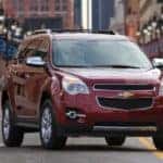 Maroon 2010 Chevrolet Equinox parked diagonally on a paced street