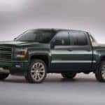 Dark colored 2014 Chevrolet Silverado truck parked in an all white showroom