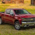 A red 2020 Chevy Silverado LTZ is parked on grass and popular among trucks for sale in Albany, NY.